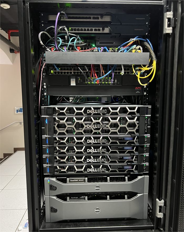 Datacenter cabinet with Dell EMC servers, network switches, and storage arrays