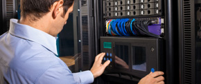Technician working inside a server cabinet